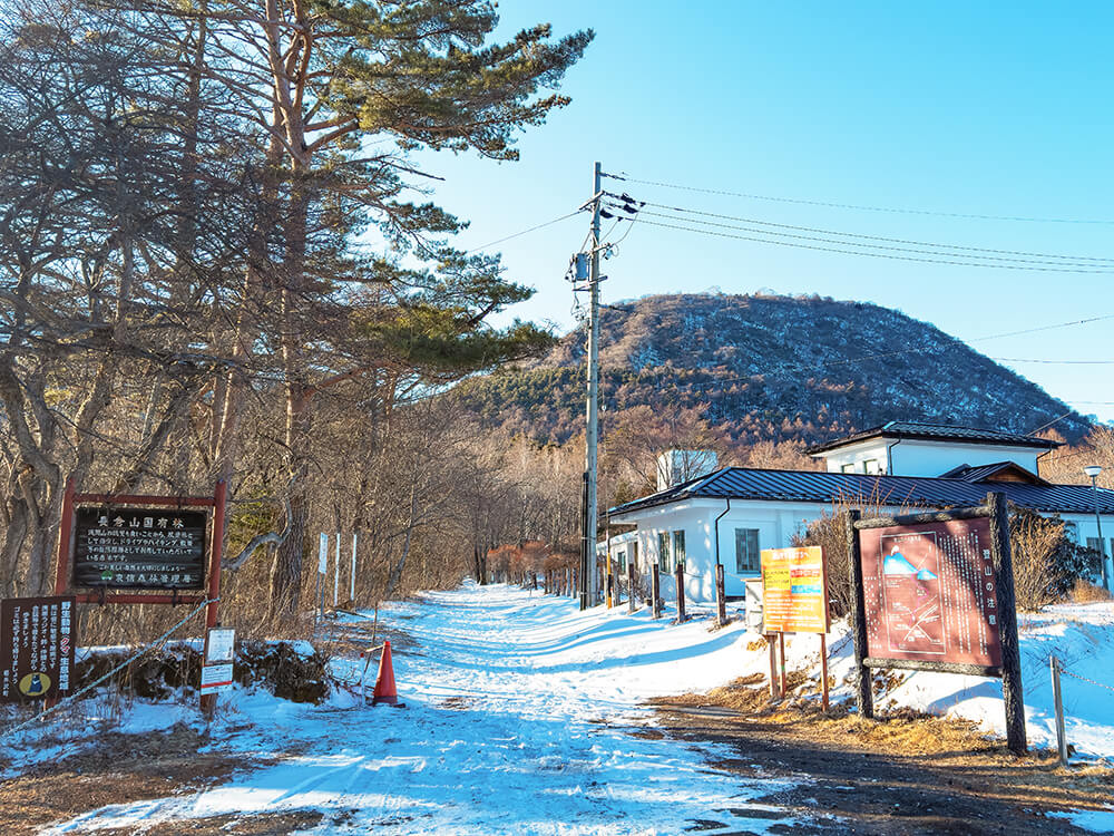 冬の小浅間山登山口にある、雪に覆われた登山届ポストと案内看板